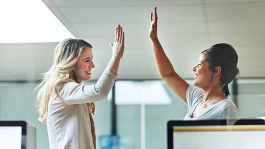 Two businesswoman high-fiving