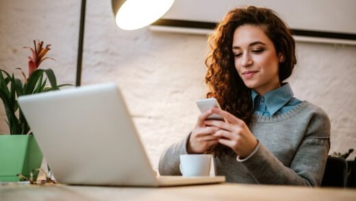 a woman looking into her phone and working - how to develop entrepreneurial skills