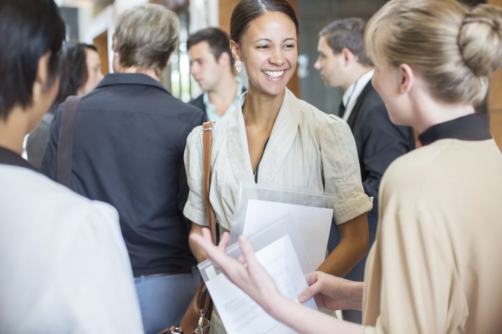 A woman talking to other workers 