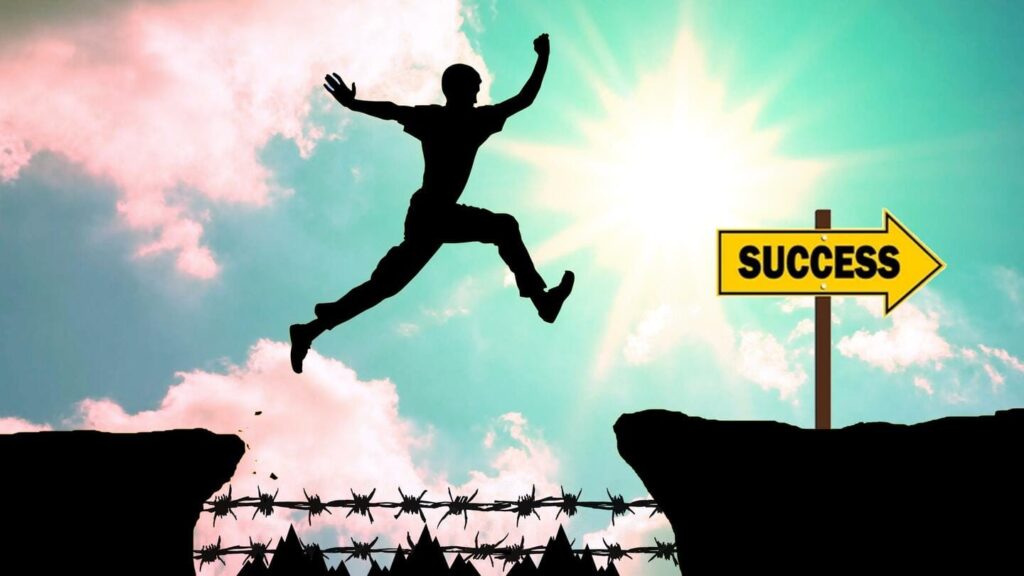 a person jumping from one cliff to another which is directed towards success